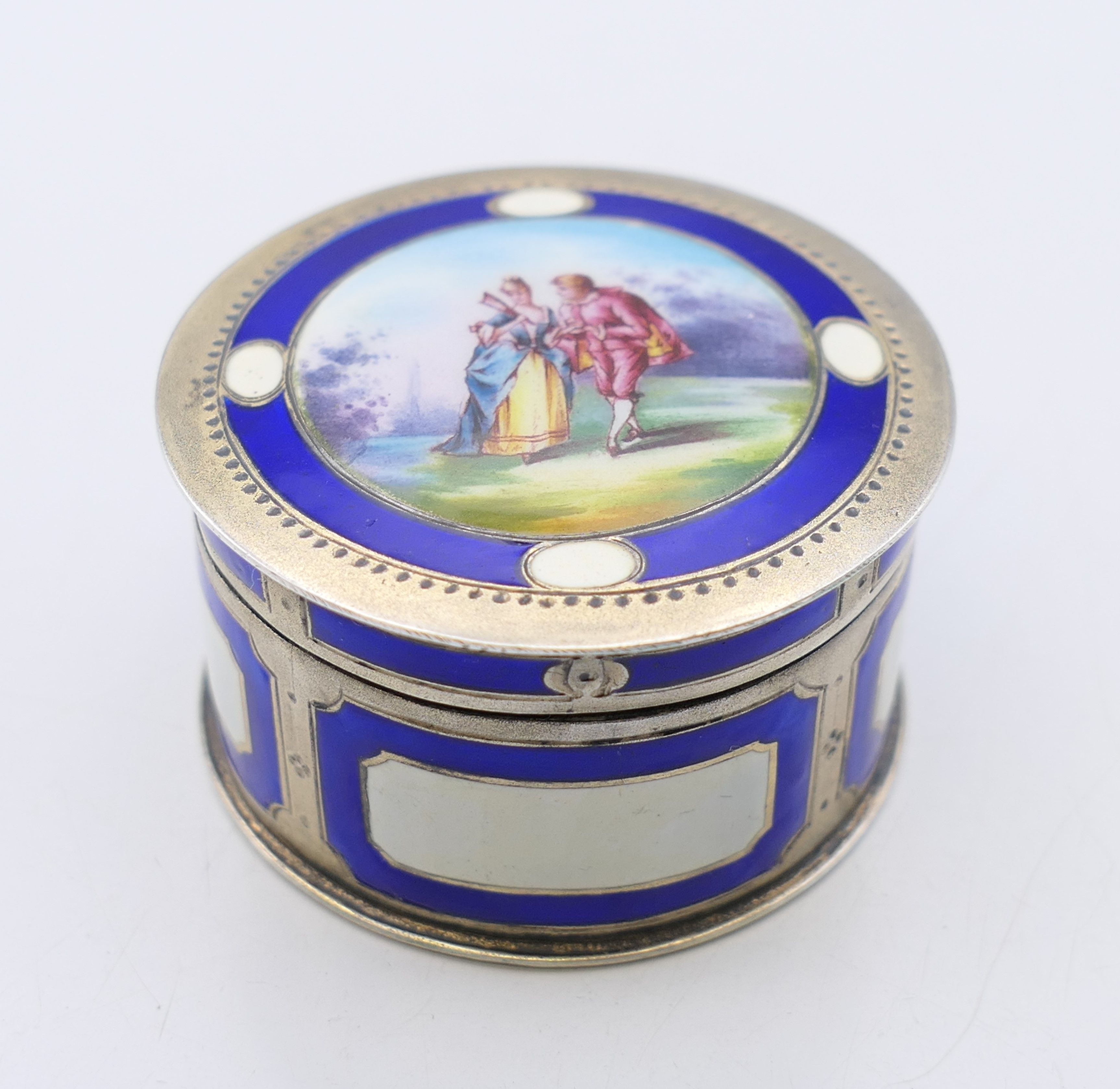 A Continental 800 silver and enamel pill box, the lid decorated with a courting couple. 4.
