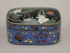 A cloisonne box decorated with butterflies amongst foliage. 7.5 cm wide.