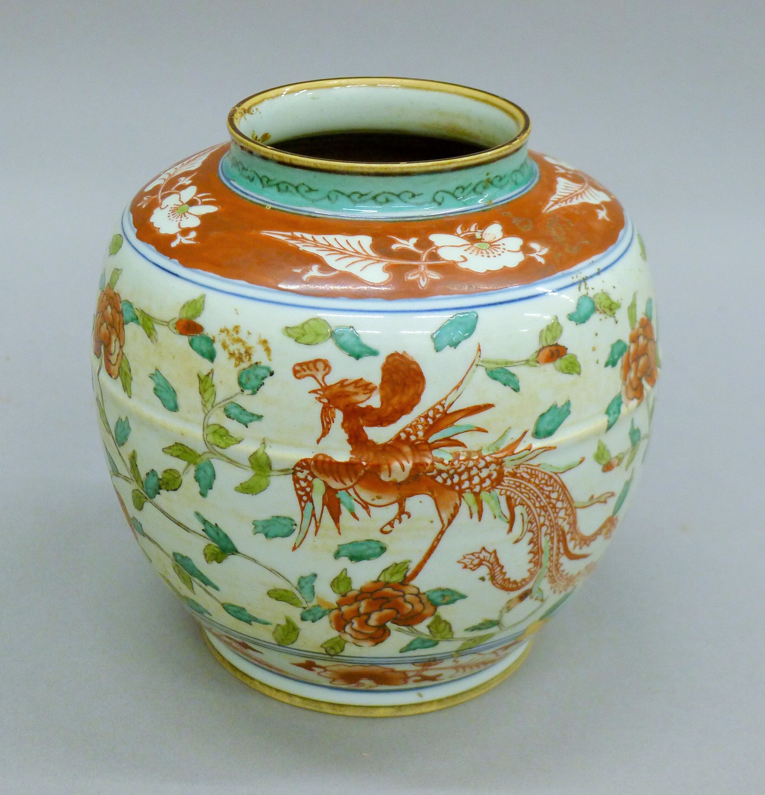 A 20th century Chinese Wucai enamelled ginger jar depicting a pair of phoenixes amongst a floral