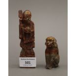 A soapstone model of Shou Lao and a soapstone model of a dog. The former 12 cm high.