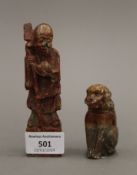 A soapstone model of Shou Lao and a soapstone model of a dog. The former 12 cm high.