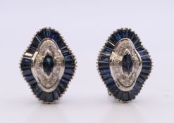 A pair of white gold diamond and sapphire earrings. 2 cm high. 15.7 grammes total weight.