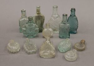 A collection of early snap neck glass scent bottles. The largest 10 cm high.