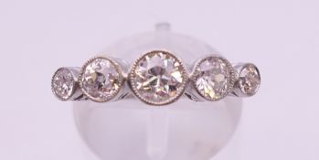 A platinum five stone diamond ring. Ring size N/O.