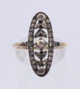 An unmarked 18 ct gold pierced scrolling diamond ring. Ring size O.