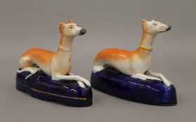 A pair of 19th century Staffordshire pottery fawn greyhounds wearing coursing collars,