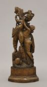 An Eastern erotic wooden carving. 26 cm high.