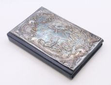 A silver fronted address book. 8 cm wide.