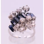 An 18 ct white gold diamond and sapphire cluster ring. Ring size M/N.