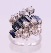 An 18 ct white gold diamond and sapphire cluster ring. Ring size M/N.