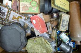 A box of miscellaneous items, including wooden figures, tins, etc.