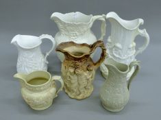 A quantity of relief moulded jugs,