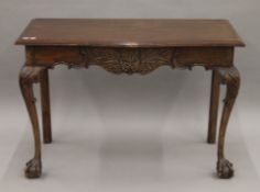 An 18th century style serpentine side table. 106 cm wide.