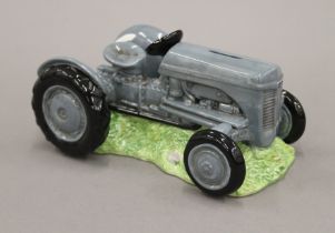 A Border Fine Arts porcelain tractor form money box. 22 cm long.