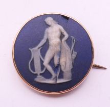 A 9 ct gold mounted Wedgwood Jasperware brooch. 2.5 cm diameter.