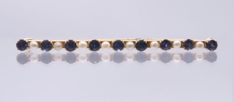 An antique natural sapphire and seed pearl bar brooch, tested high carat. 6 cm wide. 5.