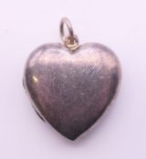 A Tiffany & Co silver heart form locket. 3.5 cm high.