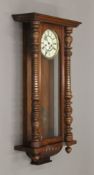 A 19th century walnut cased Vienna wall clock. 93 cm high.
