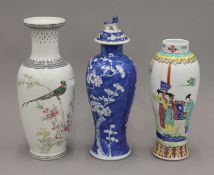 A 19th century Chinese blue and white porcelain slender vase and cover painted with prunus blossom