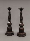 A pair of Japanese patinated bronze candlesticks decorated with dragons. 47 cm high.