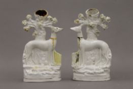 A pair of 19th century Staffordshire pottery spill vase figures of standing greyhounds wearing