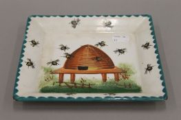 A Wemyss pottery plate decorated with a beehive. 19 cm wide.