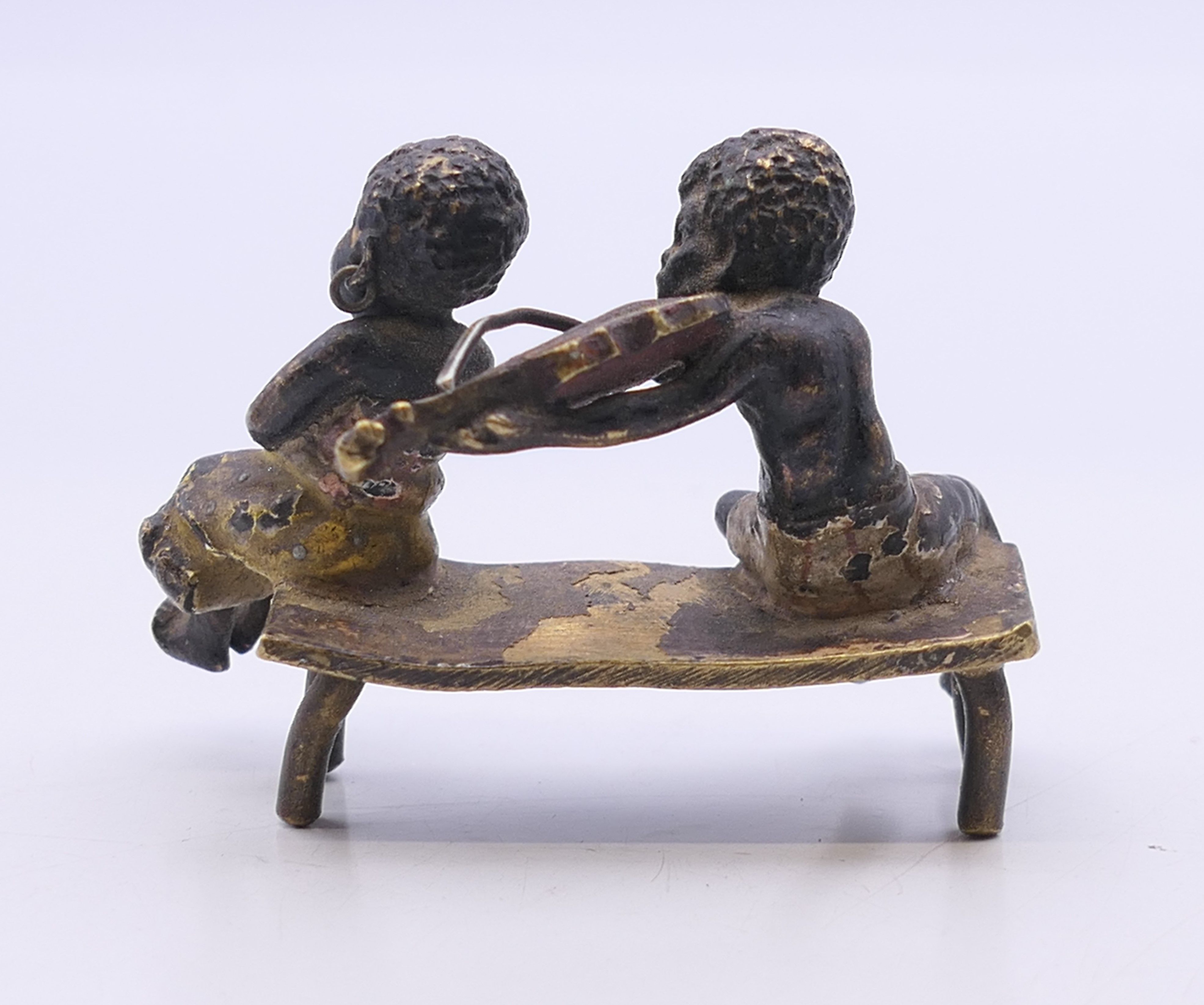 A 19th century Austrian cold painted bronze model formed as two figures seated on a bench, - Image 3 of 4