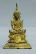 An 18th century gilded bronze Thai seated Buddha on an elaborated plinth. 19.5 cm high.