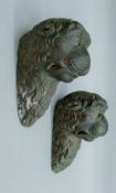 A pair of moulded lion masks. 20 cm high.