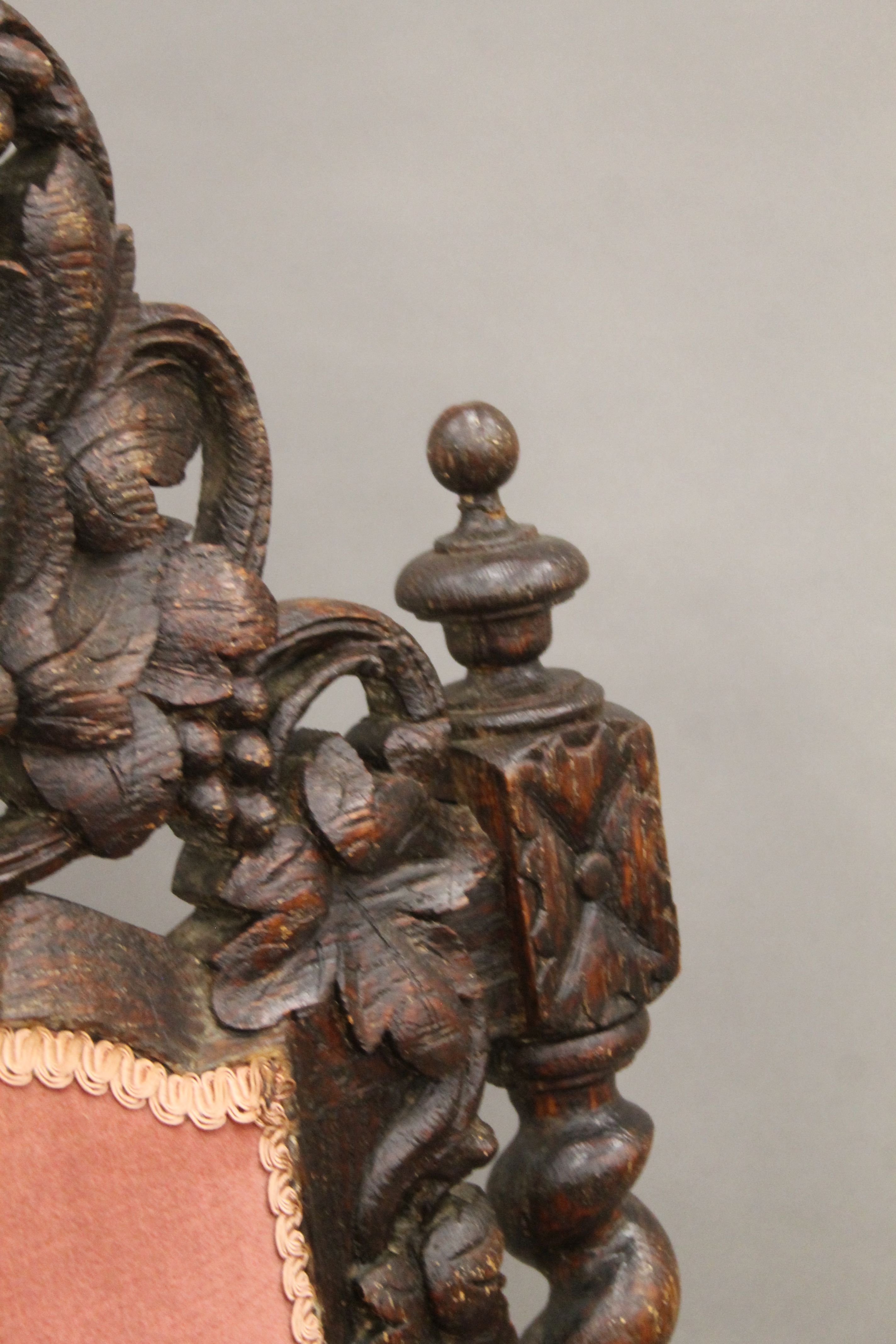 A 19th century carved oak upholstered open armchair with greenman back and dolphin form arms. - Image 5 of 7