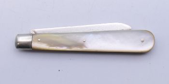 A silver and mother-of-pearl folding fruit knife. 14.5 cm long open.