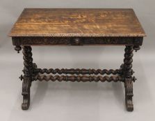 A Victorian carved oak barley twist two drawer writing table. 105 cm long.