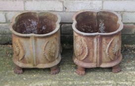 A pair of cast iron planters. Each 26 cm high, 30 cm diameter..