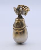 A silver helmet and egg pendant bearing Russian marks. 4.5 cm high.