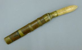 A 19th century Eastern bone-handled dagger in brass bound sheath. 23 cm long.