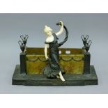 An Art Nouveau figural jardiniere. 44 cm wide.