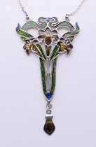 An Art Nouveau-style silver pendant on chain. The pendant 7.5 cm high.