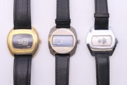 Three circa 1970's mechanical Swiss watches with digital dials. The largest 4.5 cm wide.