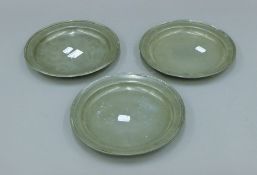 Three pewter plates. 23 cm diameter.