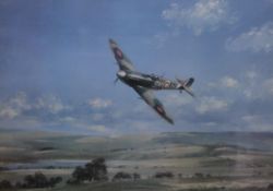 A print of a Spitfire in flight, framed and glazed. 68 x 48.5 cm.