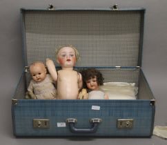 A suitcase of various dolls and child's games. The largest 50 cm high.