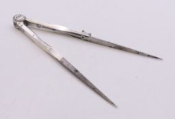 An 18th century unmarked silver drawing compass with polished steel points. 13 cm long.