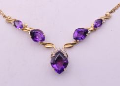 A 14 k gold amethyst and diamond set necklace. 42 cm long. 9.4 grammes total weight.