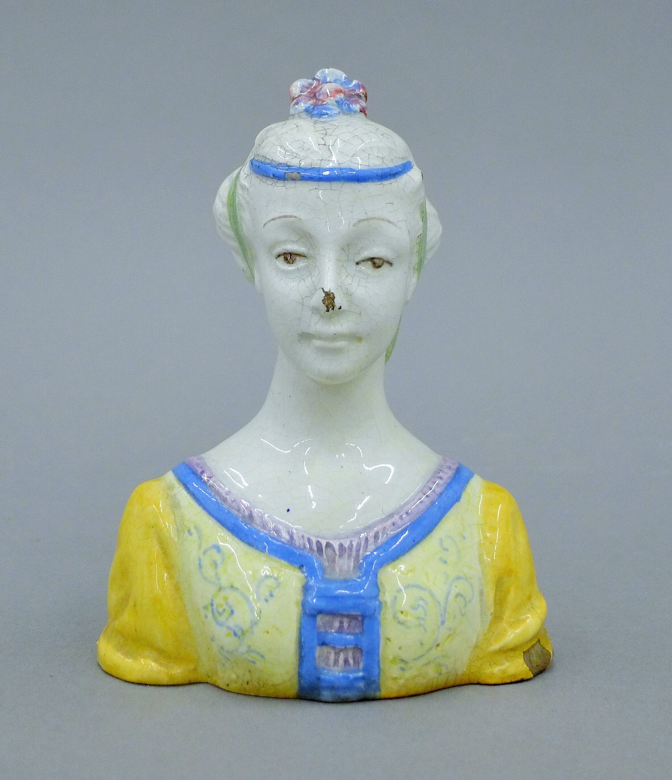 A faience porcelain bust of a lady. 13 cm high.