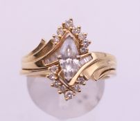 A 14 k gold and diamond ring with marquise centre stone. Ring size T.