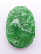 A Chinese jadite pendant formed as a Buddha. 4.5 cm high.