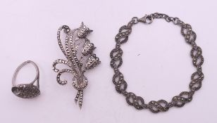 A silver marcasite brooch, bracelet and ring. The bracelet 18 cm long.