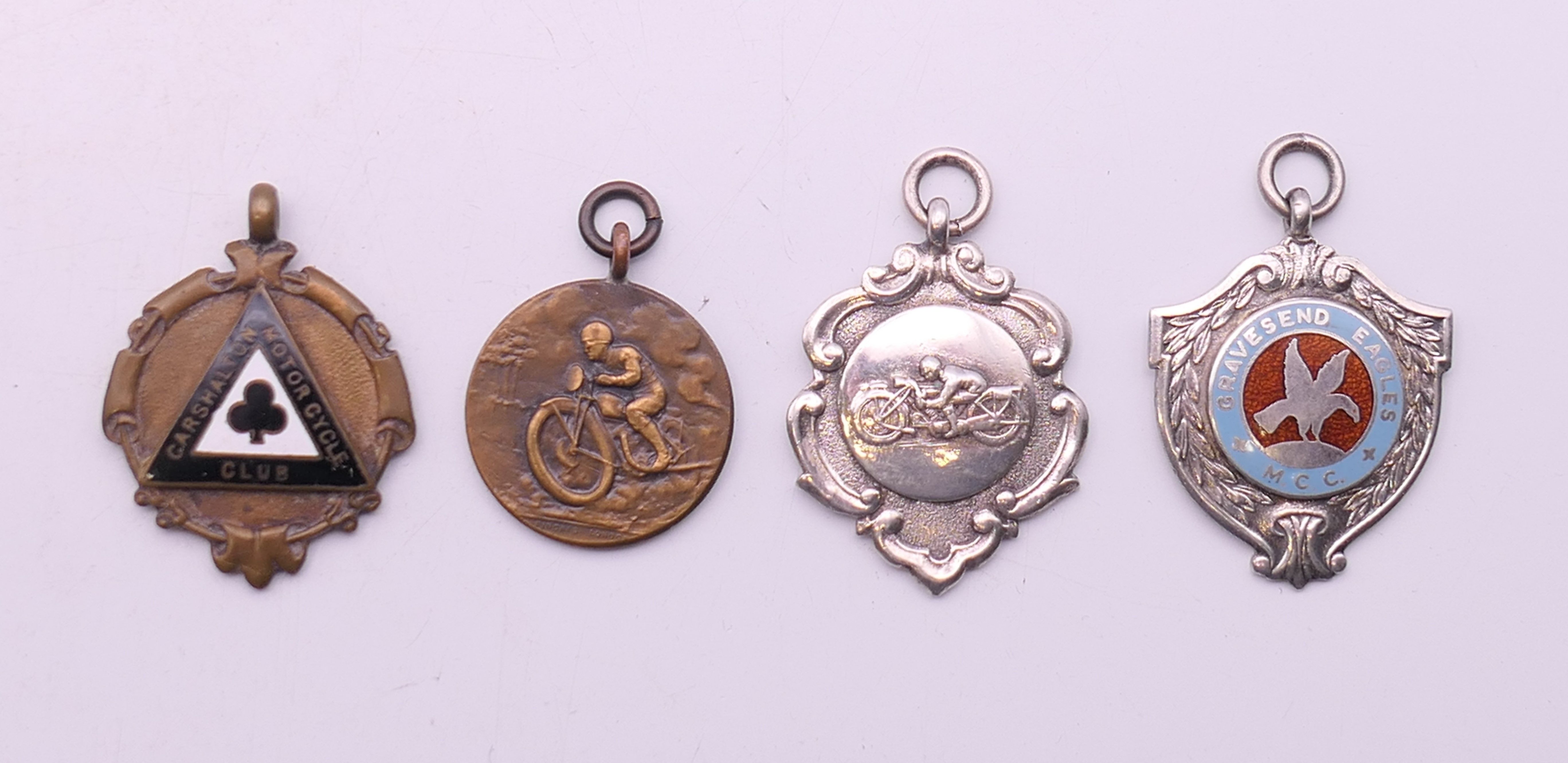 Four motorcycle fob medallions, one 1920's and three 1950's. The largest 4.5 cm high.