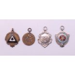 Four motorcycle fob medallions, one 1920's and three 1950's. The largest 4.5 cm high.