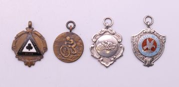 Four motorcycle fob medallions, one 1920's and three 1950's. The largest 4.5 cm high.